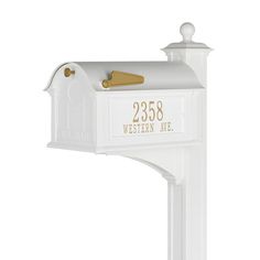 a white mailbox with gold lettering on it