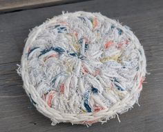 a round piece of yarn sitting on top of a wooden table