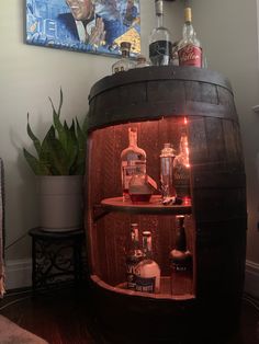 a wooden barrel filled with bottles and liquor