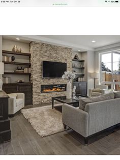 a living room filled with furniture and a flat screen tv mounted to a wall above a fireplace