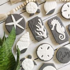 cookies decorated with sea animals and seashells are arranged on a table