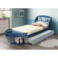 a child's bed with an ocean theme on the headboard and foot board