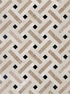 a tile floor with black and white squares on it's sides, in the shape of a chevron herringbone pattern