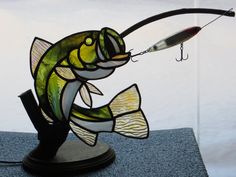 a stained glass fish is hooked up to a fishing rod with a hook in it