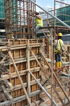 construction workers are working on the building under construction with scaffolding and safety equipment