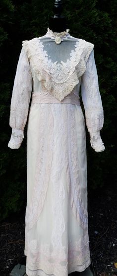 Antique 1900's French Alençon /silk lace lady Edwardian wedding dress color soft peal pink/ecru. In good antique condition, Some holes with old repair and few stain in it, The pictures is part description. Sold as is, Not sure the size. It's 100% cotton . Weighs 14 Oz. Sale dress only.  Thanks. Collar part 14" long Shoulder: 14" Waist 31" long Bust: 36" long Sleeves  23"1/2long Dress 57" long Ship US only Pink Silk Wedding Dress, Vintage Lace Dress For Costume, Victorian Vintage Dress For Vintage Events, Elegant White Wedding Dress For Costume, White Victorian Dress With Lace For Vintage Events, White Victorian Dress With Lace Work For Vintage Events, Elegant Victorian Dress With Lace Trim For Vintage Events, Vintage White Gown For Vintage Events, Cream Vintage Wedding Dress