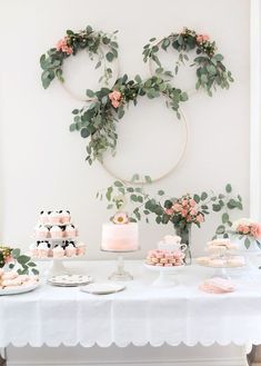 a white table topped with cakes and desserts