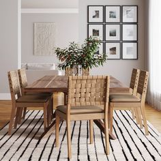 a dining room table with chairs and a potted plant in the corner on top of it