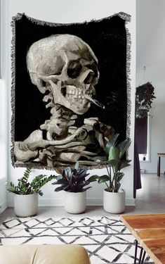 a living room with a couch and a large skull tapestry hanging on the wall