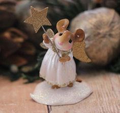 a figurine of a mouse holding a star