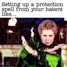 an image of a woman with her hands up in front of the caption that reads, setting up protection spells against haters like