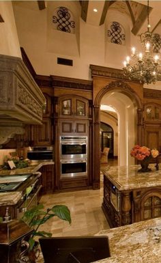 a large kitchen with marble counter tops and an island in the middle of the room