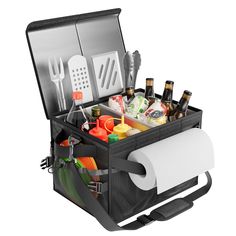 an open lunch box with utensils and bottles in it on a white background