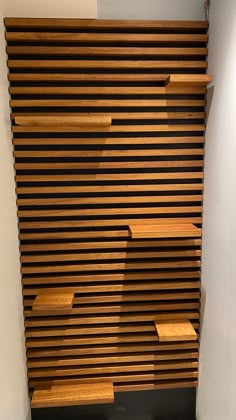 a wooden shelf sitting on the side of a wall