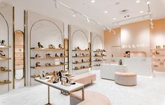 the inside of a shoe store with marble floors and shelves filled with high heeled shoes