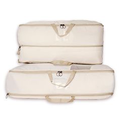 two white suitcases sitting side by side on top of each other in front of a white background