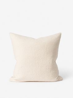 a white pillow sitting on top of a table