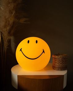 a smiley face lamp sitting on top of a table