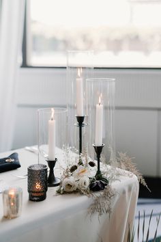 a table with candles and flowers on it