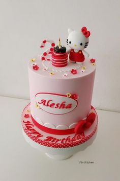 a hello kitty birthday cake on a white table