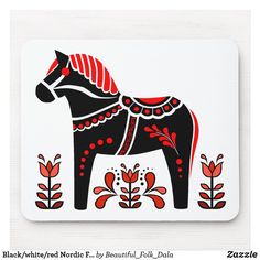 a black and red horse with flowers on it's back side is shown in this mouse pad