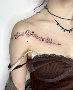 a woman with a tattoo on her shoulder