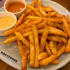 french fries on a plate with dipping sauce