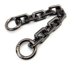 a black metal chain is shown on a white background with clippings to the side