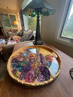 a table with a glass plate on it and a lamp in the corner next to it