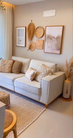 a living room filled with furniture and pictures on the wall