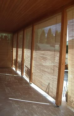 an empty room with wooden slats on the walls