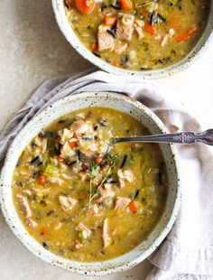 two bowls filled with chicken and vegetable soup