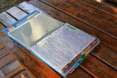 an open notebook sitting on top of a wooden table