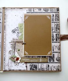 a scrapbook with an empty page and some papers