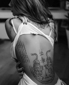 a woman with a tiger tattoo on her back