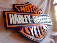 the harley davidson logo is displayed on a wall