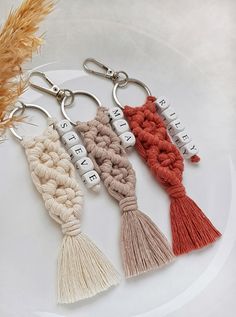 four tasseled key chains on a white plate