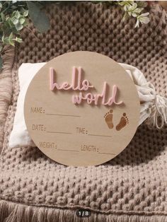 a wooden sign that says hello world with baby feet on it and the words make time for weight