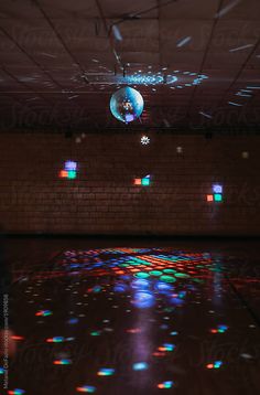 an empty room with disco lights on the floor by jodi lenski for stocksy photography