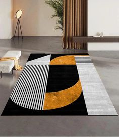 a black and white area rug with an orange circle on it in a living room