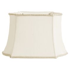 a white lamp shade with beading on the bottom and an off - white base