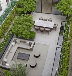 an aerial view of a patio with seating and trees in the backgrouds