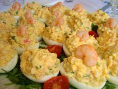 deviled eggs filled with shrimp and tomatoes