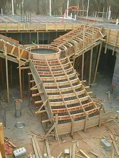 a large wooden structure being built on the side of a building