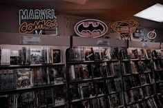 there are many movies on the shelves in this room, including batman and superman comics