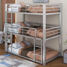 a metal bunk bed with two sets of mattresses on the top and bottom tier