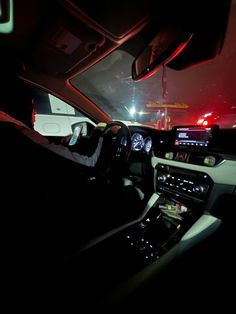 the interior of a car at night with its lights on