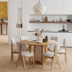 a dining room table with white chairs around it