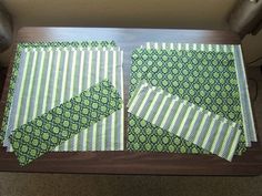 two pieces of fabric sitting on top of a wooden table