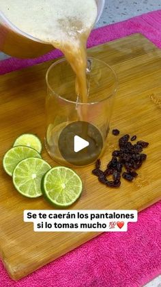 someone is pouring tea into a glass with limes and raisins on the side